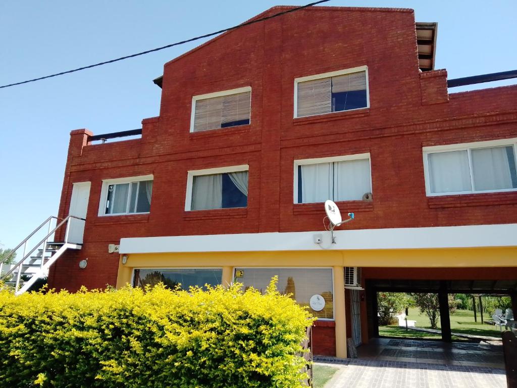 a red brick building with a garage at Cabañas Los Teros in San Pedro