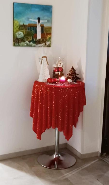 a table with a red table cloth on it at Pension Waldesruh in Linz