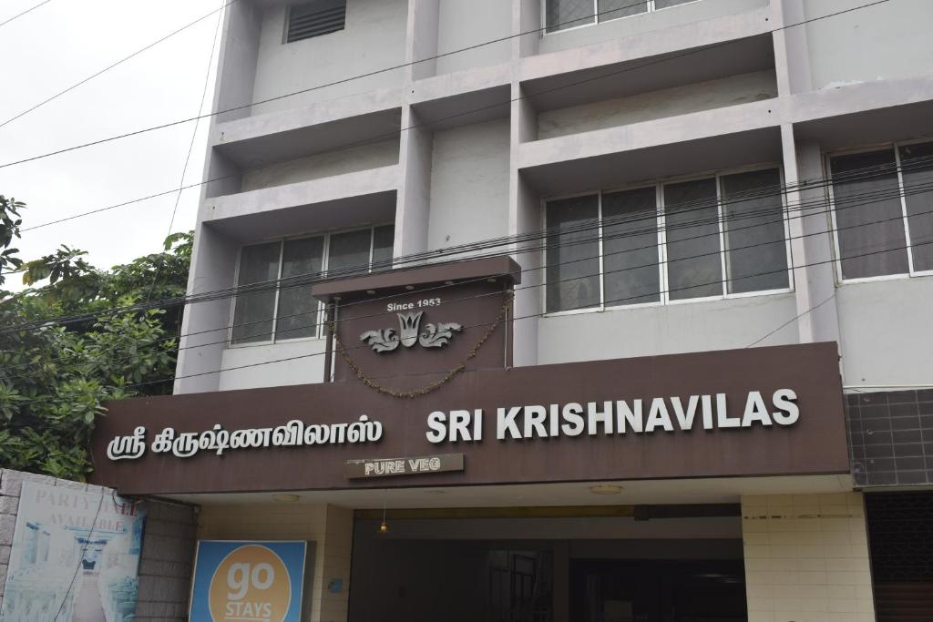 a building with a sign on the front of it at Sri Krishna Vilas in Coimbatore