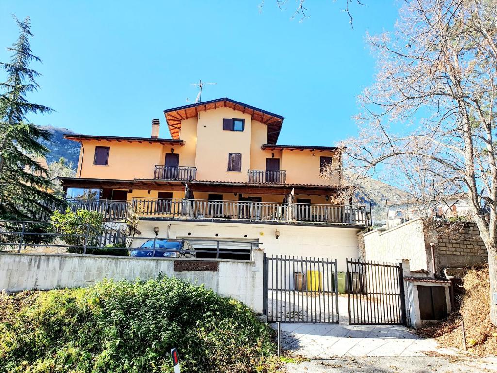 a house with a fence in front of it at La casa di Olivia in Rocca di Cambio