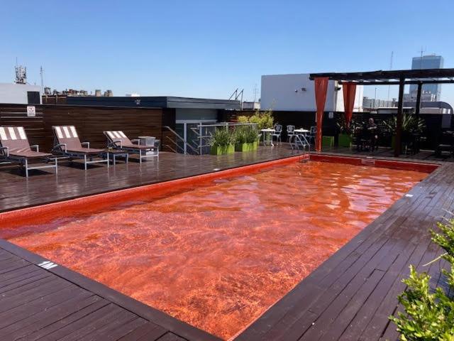 a large red rug on a roof of a building at Broadway Hotel & Suites in Buenos Aires