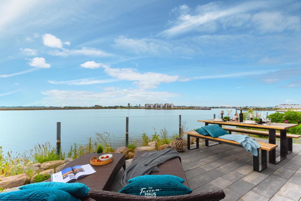 a patio with a view of a body of water at Sea 65 in Olpenitz