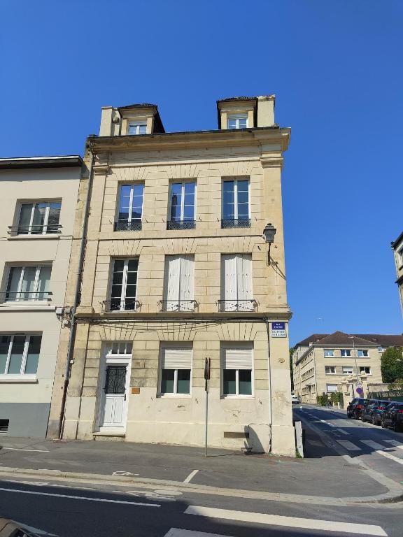un vieux bâtiment en briques au coin d'une rue dans l'établissement L'expérience d'Elie by Icone Collection, à Caen