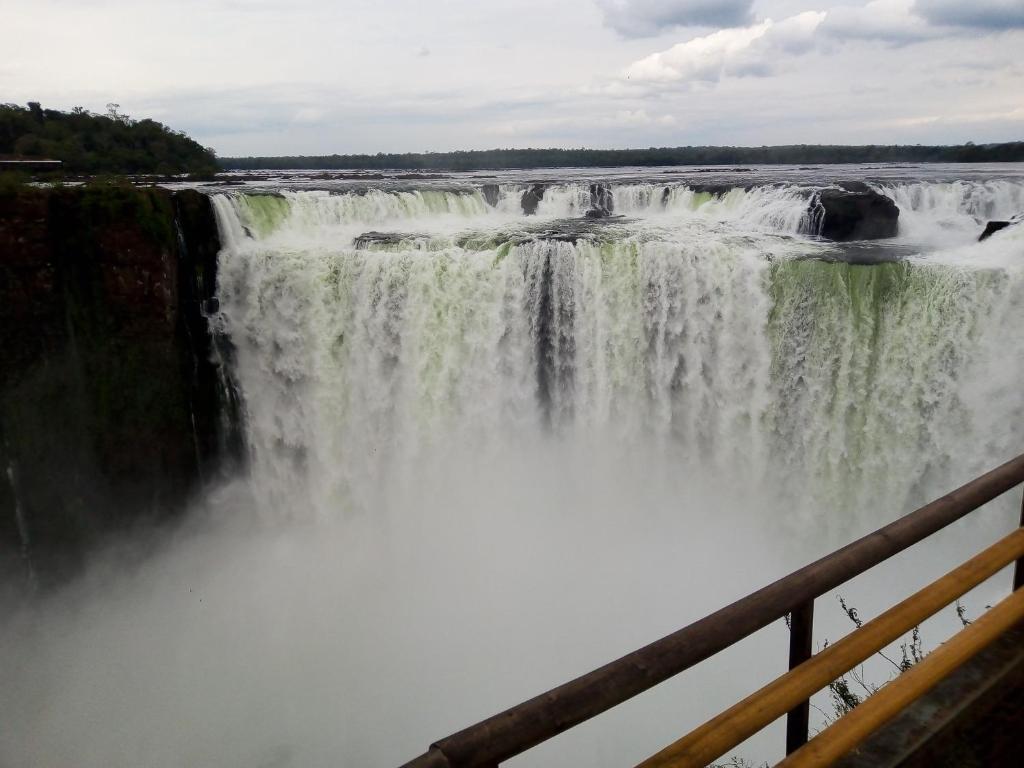 a view of a waterfall from a bridge at jazmin apart iguazu in Puerto Iguazú