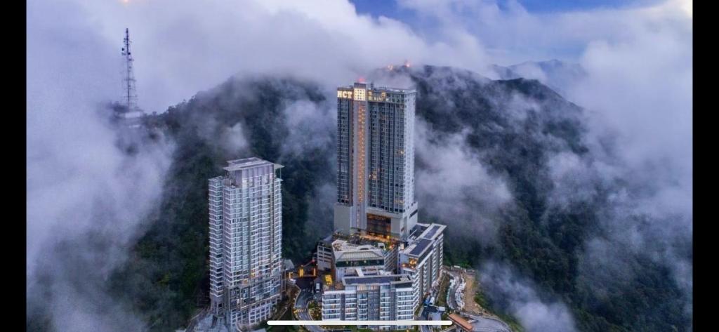 a tall building in the middle of a foggy city at TopSuites at Ion-Delemen Genting Highlands in Genting Highlands