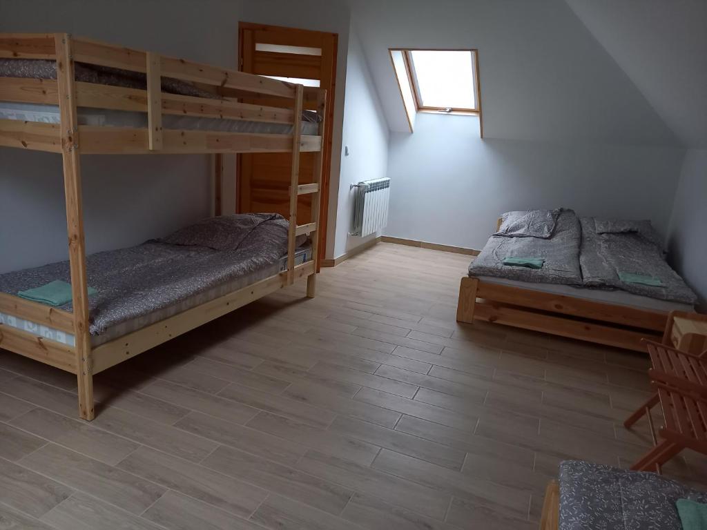 a room with two bunk beds and a window at Willa Rudenka in Rudenka