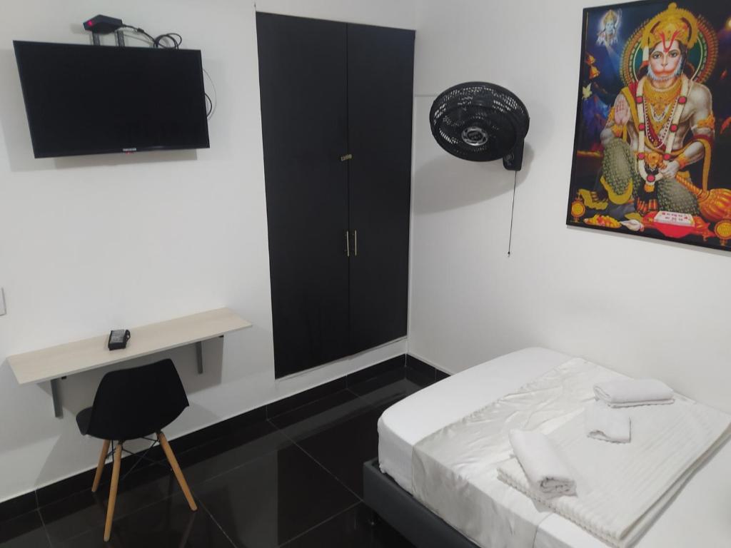 Postel nebo postele na pokoji v ubytování Hotel Aura Medellin