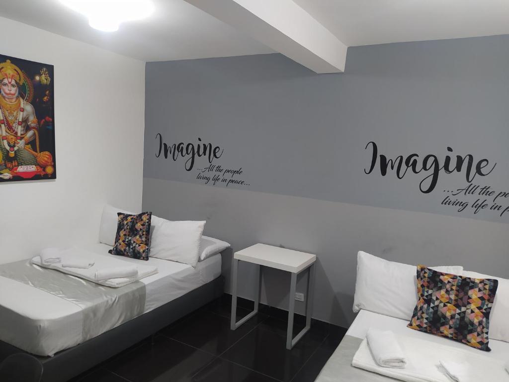 Postel nebo postele na pokoji v ubytování Hotel Aura Medellin