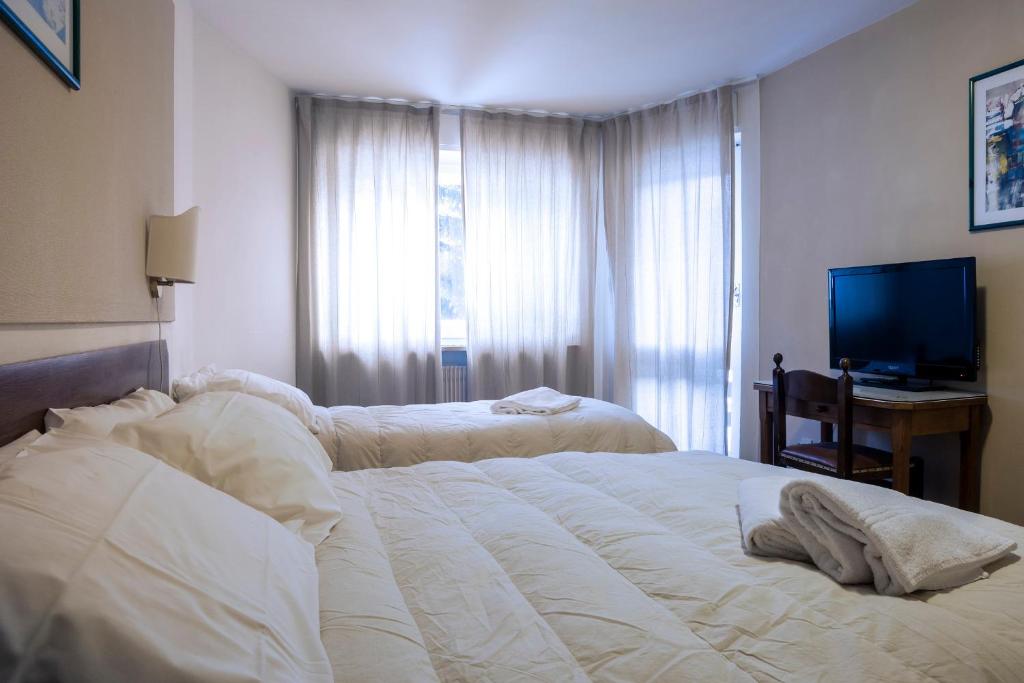 Postel nebo postele na pokoji v ubytování Hotel Hermitage