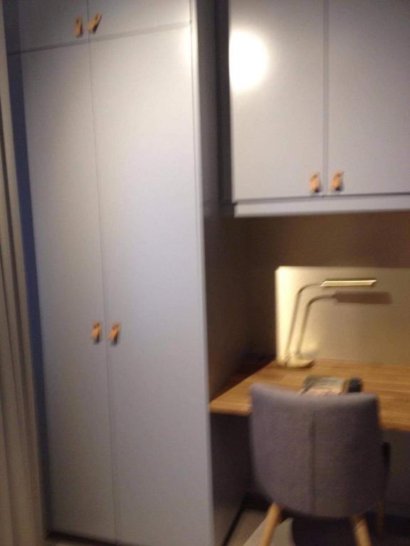 a room with a desk and a chair and a cabinet at Avanti Apartment Hotel in Stockholm