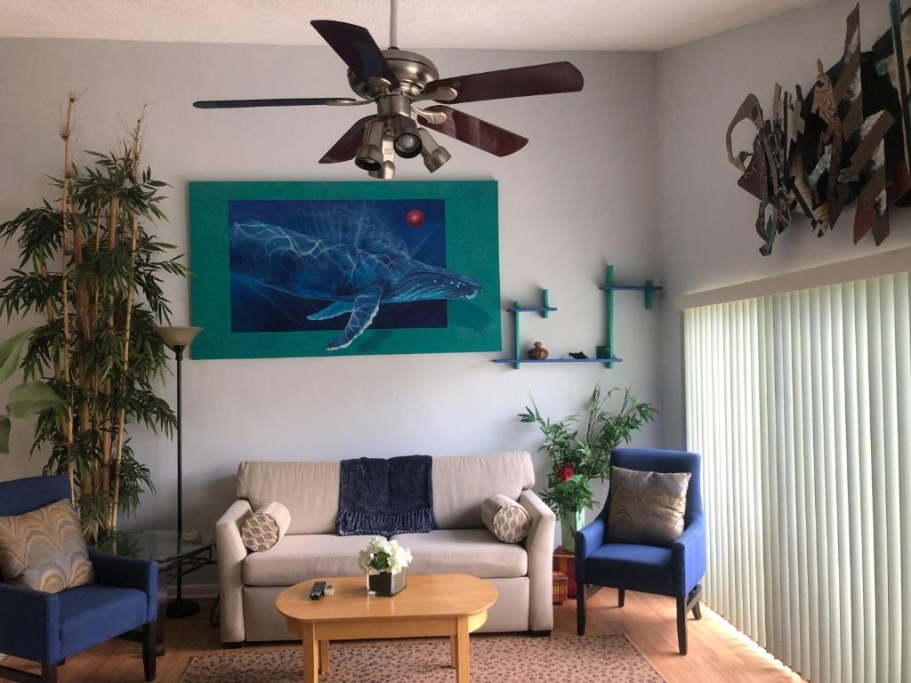 a living room with a couch and a ceiling fan at Florida Condos on Lake Tarpon in Palm Harbor