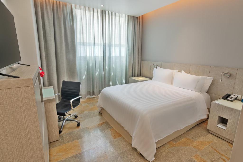 Postel nebo postele na pokoji v ubytování GHL Hotel Monteria