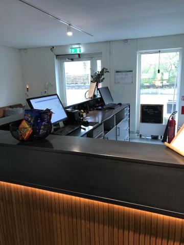 a bar in a kitchen with two laptops on a counter at Avanti Apartment Hotel in Stockholm
