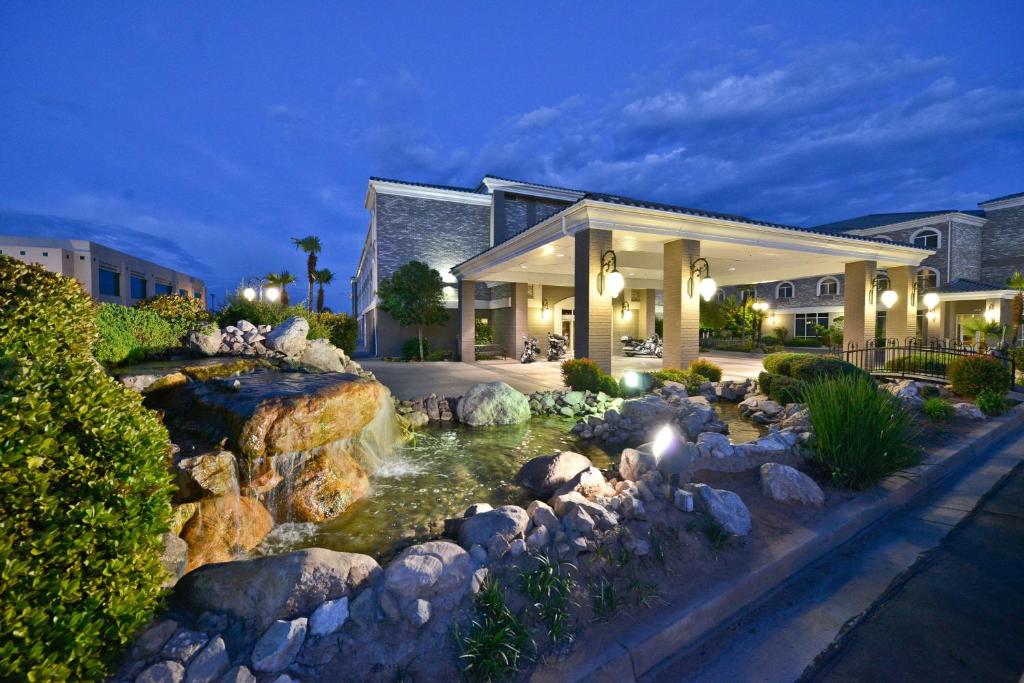 a home with a pond in front of a building at Best Western Plus Abbey Inn in St. George
