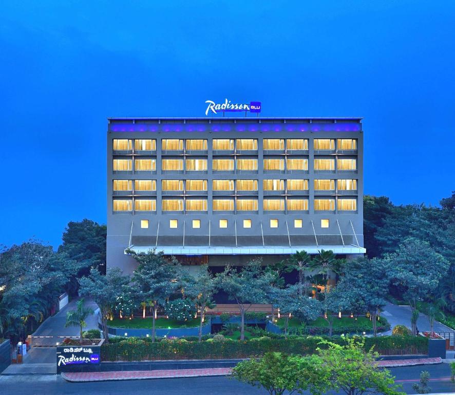 a hotel with a sign on the side of it at Radisson Blu Bengaluru Outer Ring Road in Bangalore