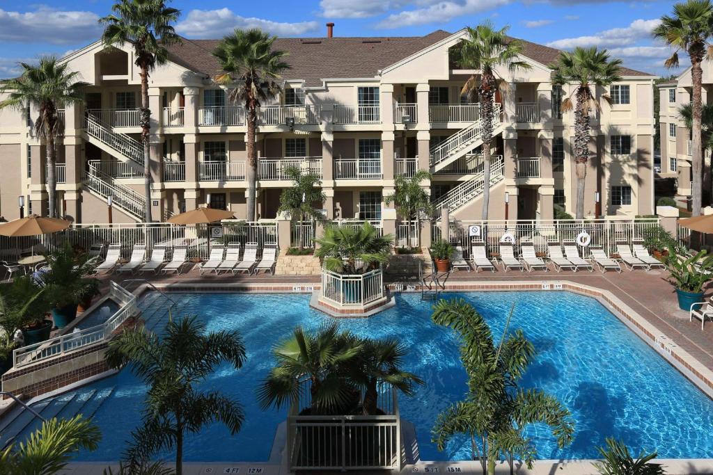 a large swimming pool with a large building at Sonesta ES Suites Orlando - Lake Buena Vista in Orlando