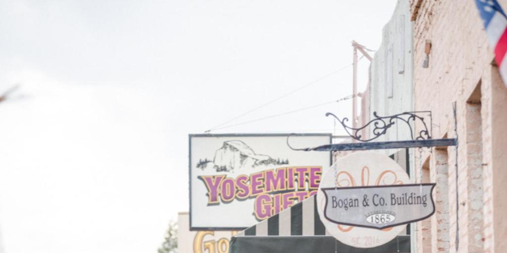 a group of signs on the side of a building at AutoCamp Yosemite in Midpines