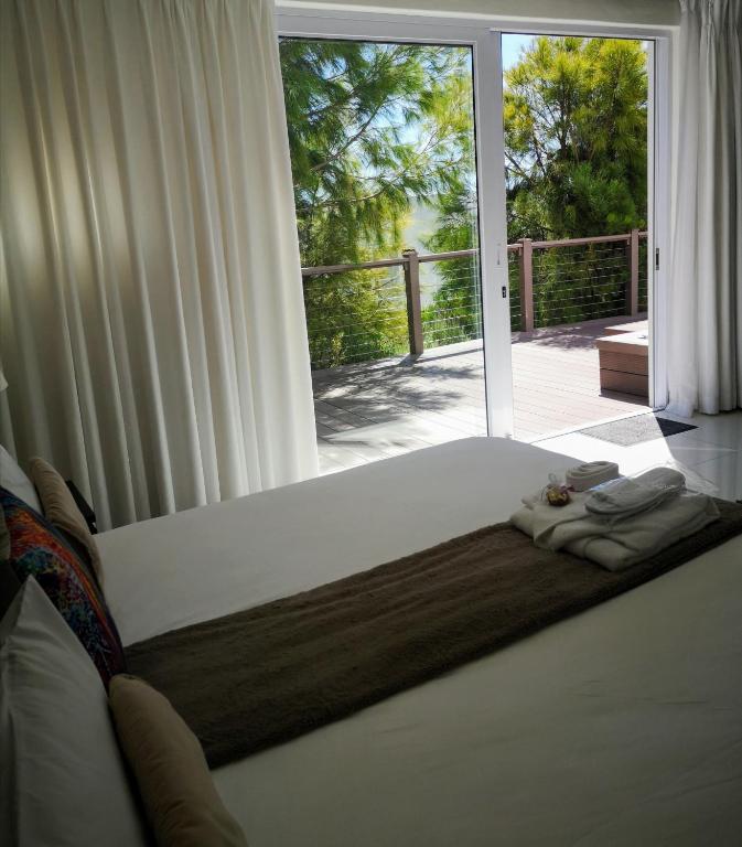 a bed in a room with a large window at Diamond House Guesthouse in Cape Town