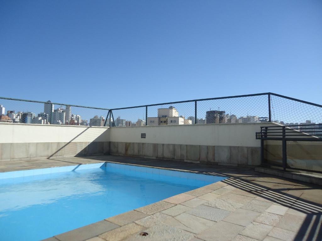 a swimming pool on the roof of a building at Residencial Genéve in Sao Paulo