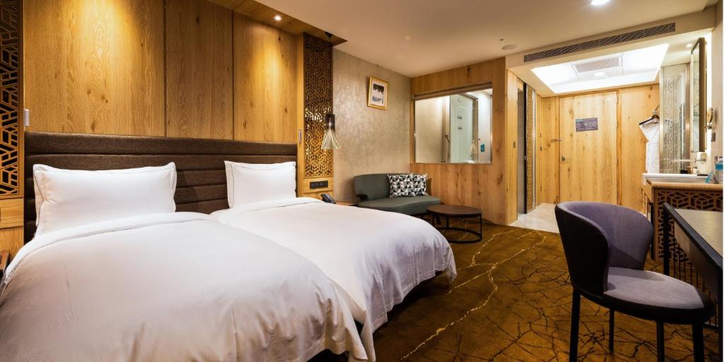 Postel nebo postele na pokoji v ubytování Hotel Château Anping