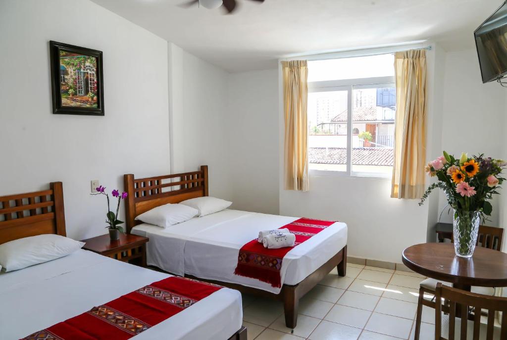Postel nebo postele na pokoji v ubytování Vallartasol Hotel