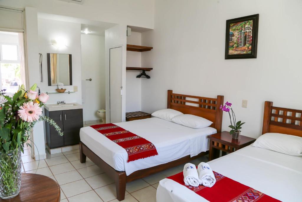 Postel nebo postele na pokoji v ubytování Vallartasol Hotel