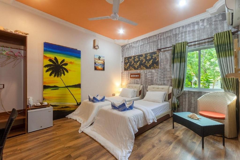 Postel nebo postele na pokoji v ubytování Coral Queen Villa, Ukulhas