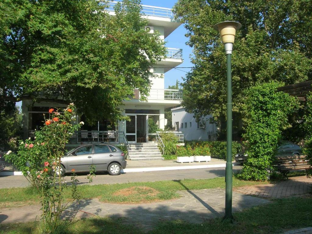 a car parked in front of a house with a light pole at Ermis in Loutra Ipatis