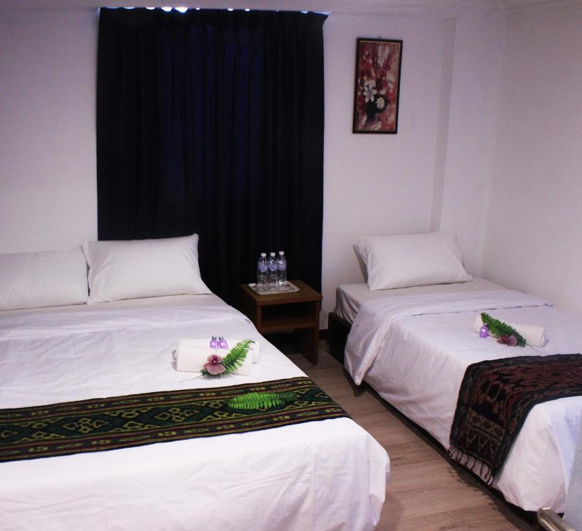 Postel nebo postele na pokoji v ubytování Kapit Hotel