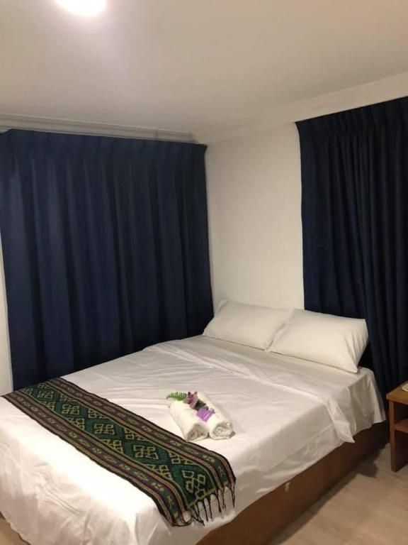 Postel nebo postele na pokoji v ubytování Kapit Hotel
