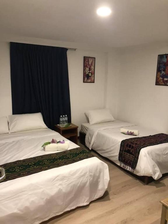 Postel nebo postele na pokoji v ubytování Kapit Hotel