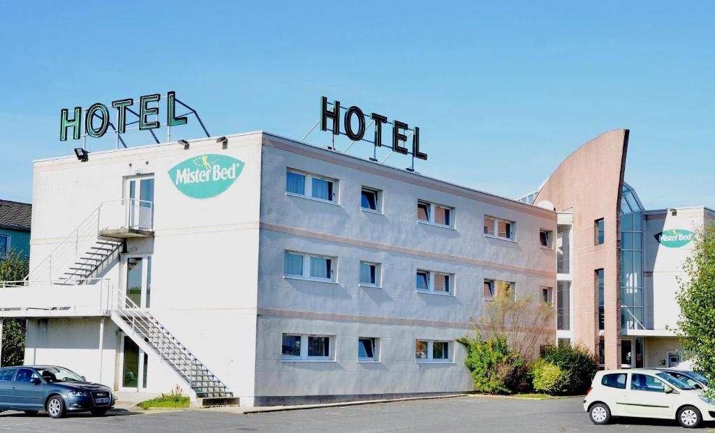 a hotel with a sign on top of it at Mister Bed Chambray Les Tours in Chambray-lès-Tours