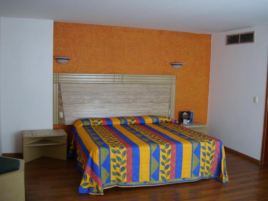 Postel nebo postele na pokoji v ubytování Hotel Cervantes