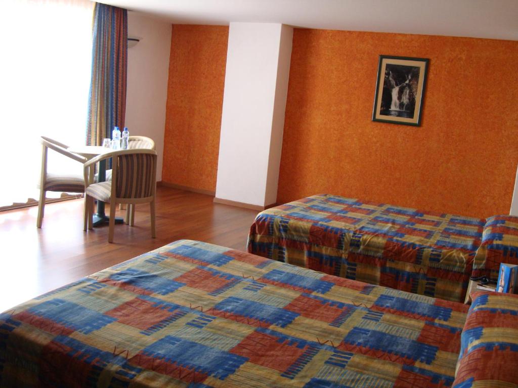Postel nebo postele na pokoji v ubytování Hotel Cervantes