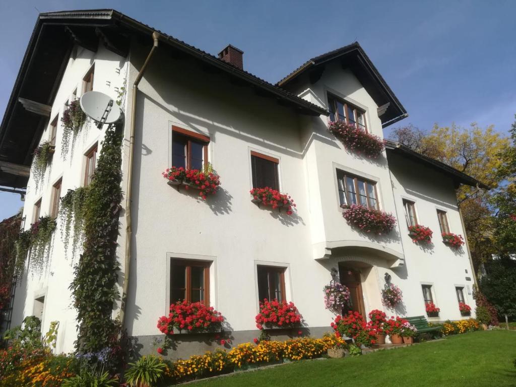 a white building with flower boxes on the windows at Bauernhof Plachl in Lassing