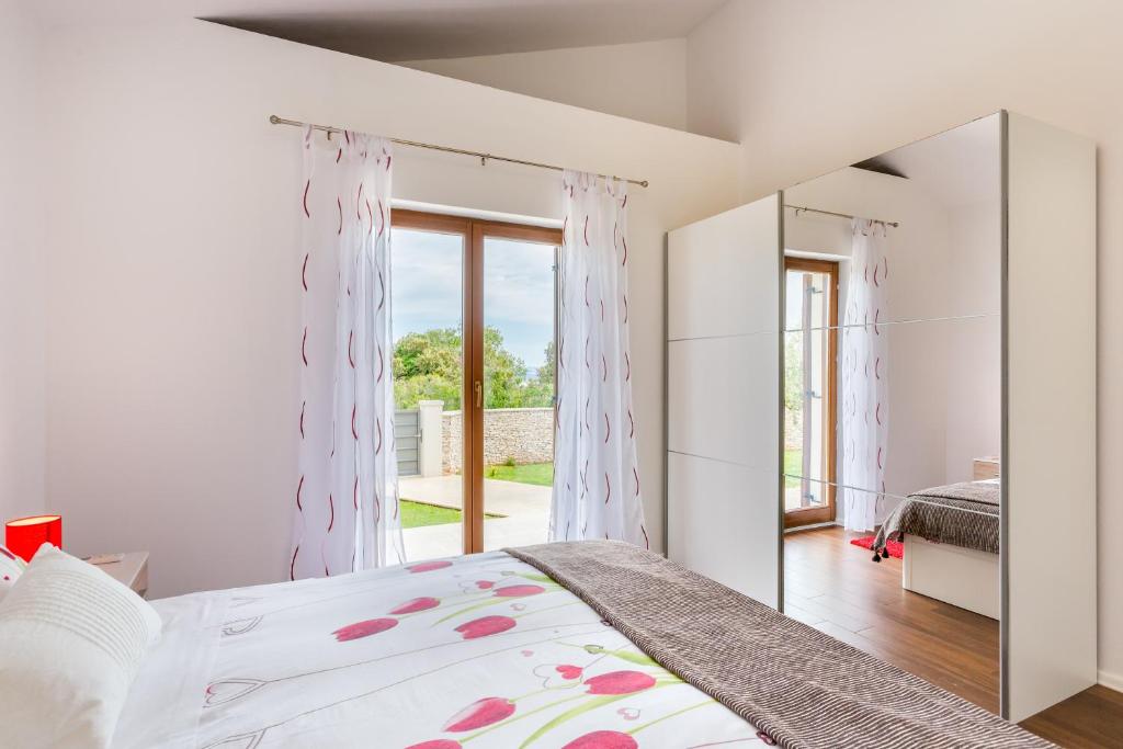 Łóżko lub łóżka w pokoju w obiekcie Villa Vignola