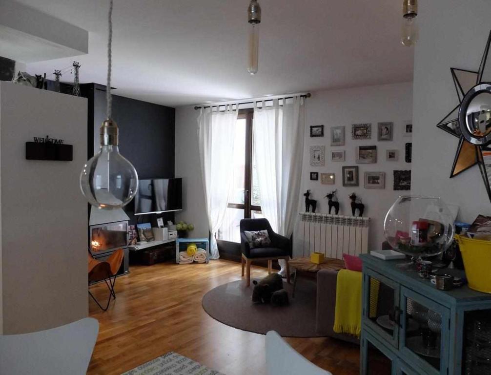 a living room with a large window and a living room with a table at UP BENASQUE Borda Albar in Benasque