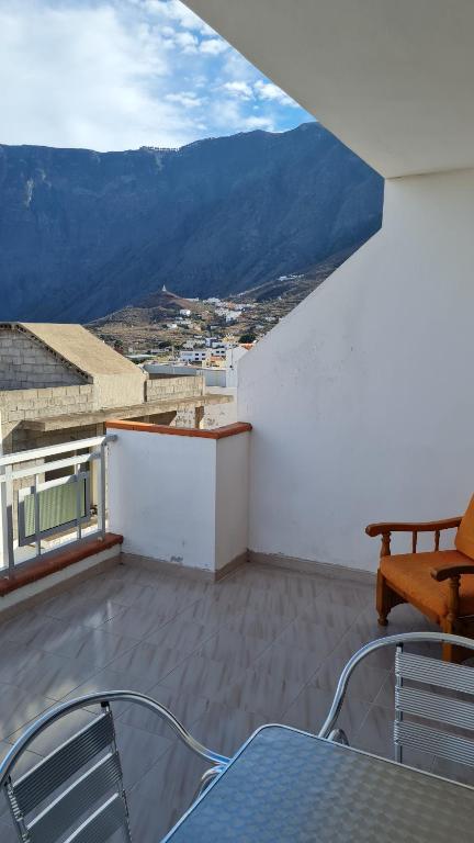 a balcony with a table and chairs on a roof at Apartamentos El Valle in Frontera