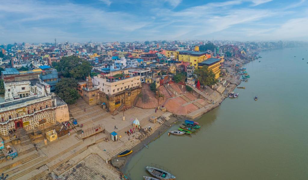 an aerial view of a city next to the water at Amritara Suryauday Haveli in Varanasi