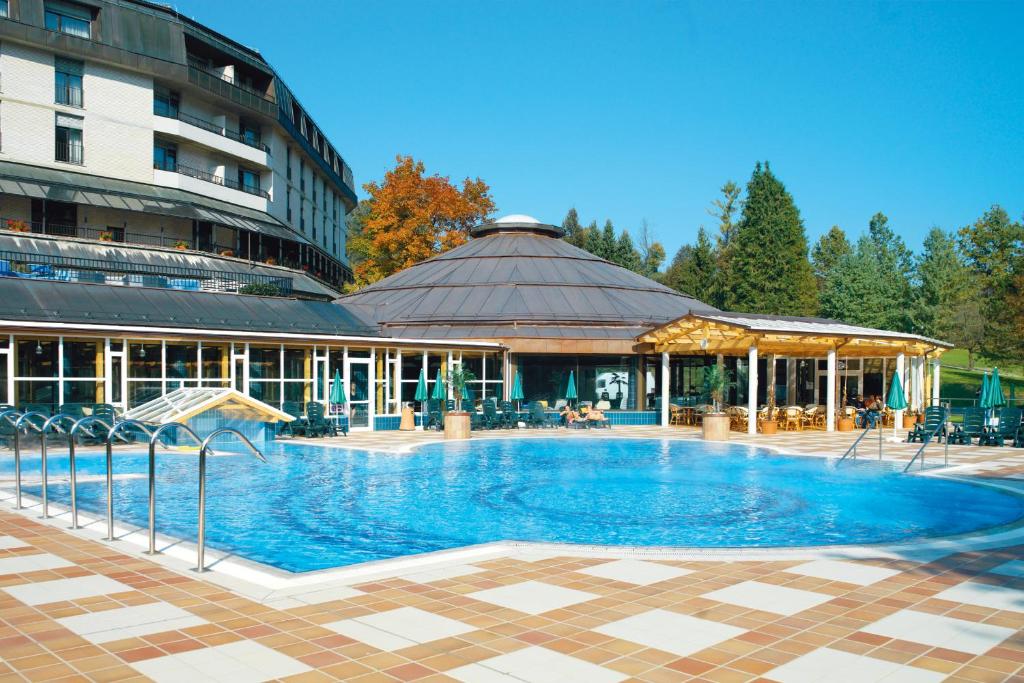 a large swimming pool in front of a building at Hotel Toplice - Terme Krka in Smarjeske Toplice