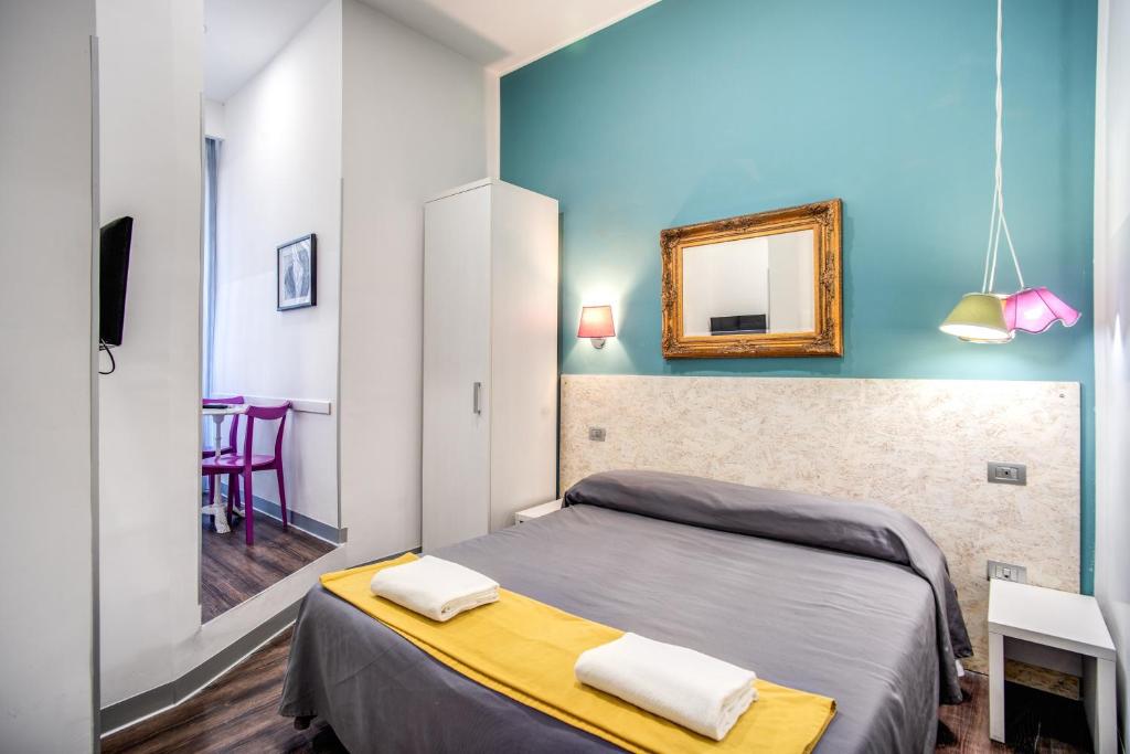 a small bedroom with a bed and a mirror at Hotel Seiler in Rome