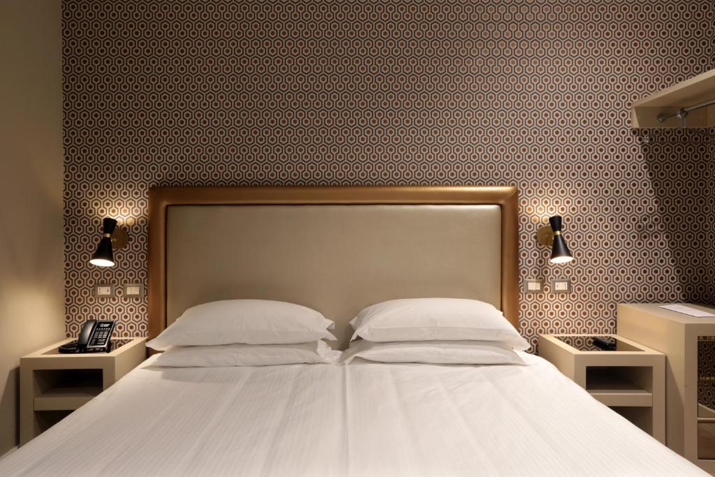 Łóżko lub łóżka w pokoju w obiekcie Caruso Place Boutique & Wellness Suites