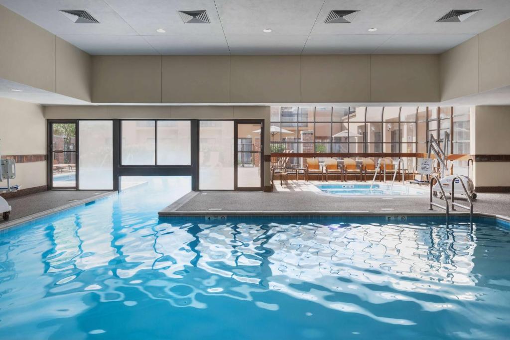 a large pool with blue water in a building at Sonesta Select Newport Middletown in Middletown