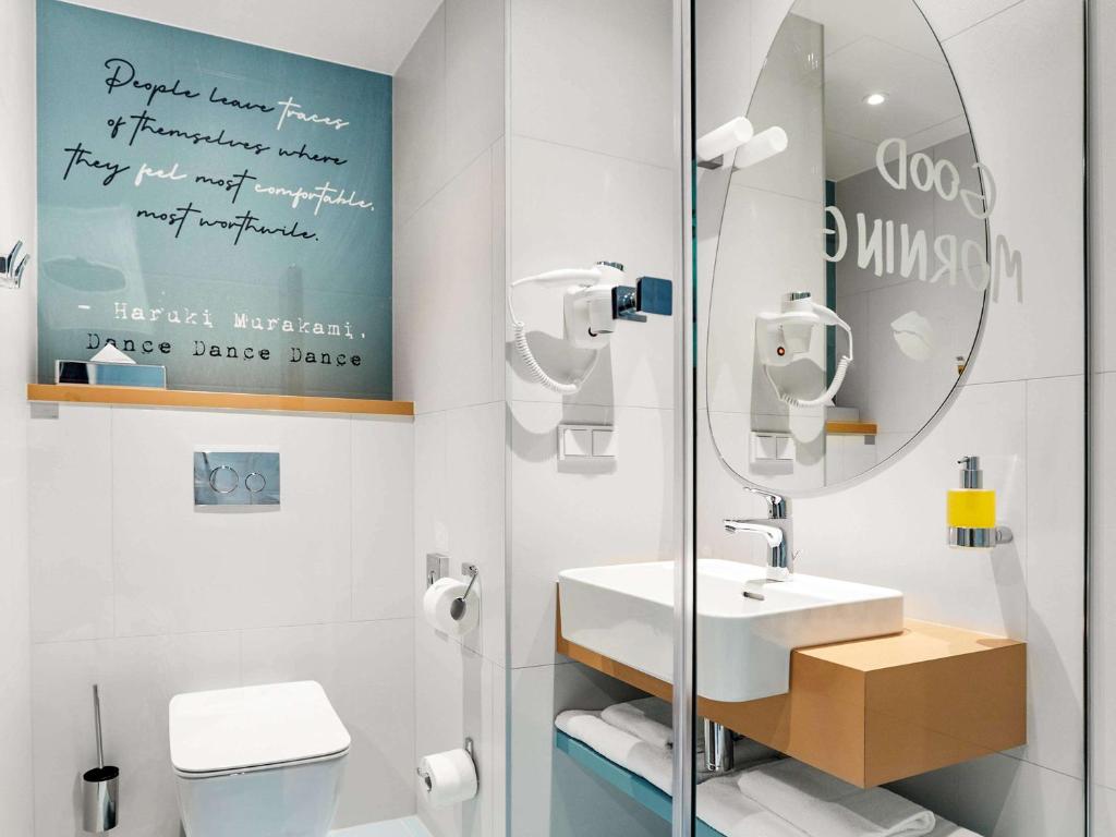 a bathroom with a sink and a mirror at ibis Styles Kraków Centrum in Krakow