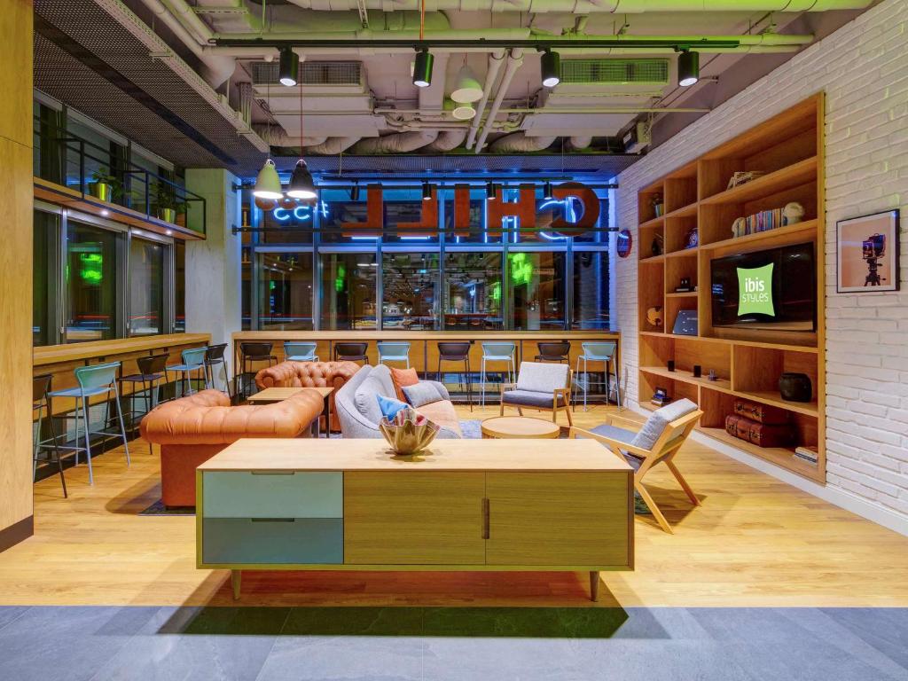 a living room with a couch and a table at ibis Styles Kraków Centrum in Krakow