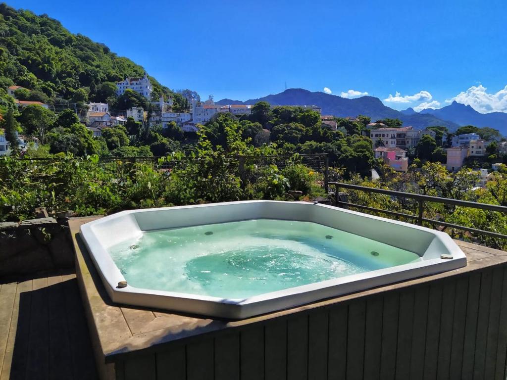 a bath tub sitting on top of a balcony at Sant' Martre in Rio de Janeiro