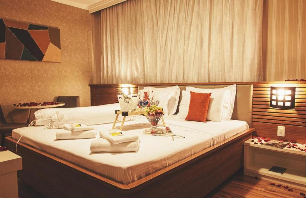 Postel nebo postele na pokoji v ubytování Class Hotel Alfenas