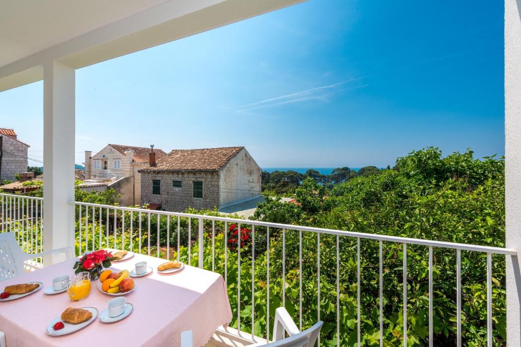 a balcony with a table with food on it at Apartment Lena in Dubrovnik