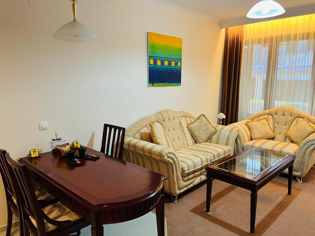 a living room with two couches and a table at Luxury Downtown Apartment - Gondola in Bansko