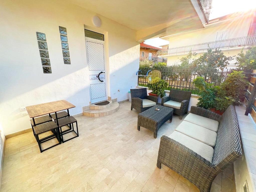 a patio with chairs and tables and a table at La Dimora della Fenice in Fondi